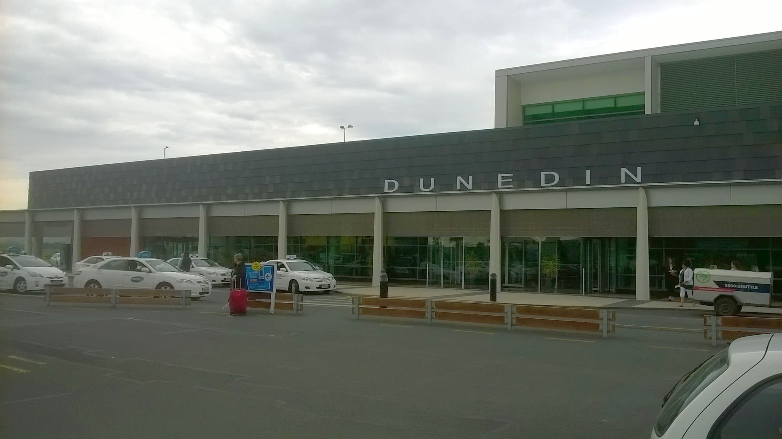 Dunedin Airport terminal facade with the airport name above its entrance