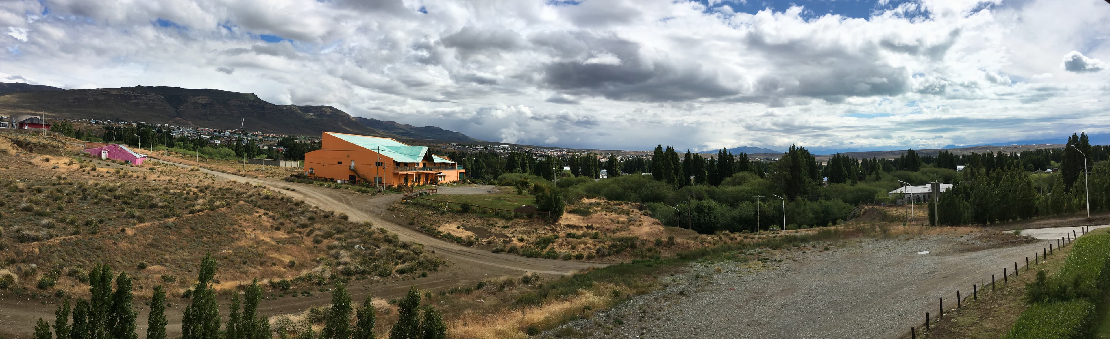 Panoramic view of El Calafate buildings, trees and surrounding hills