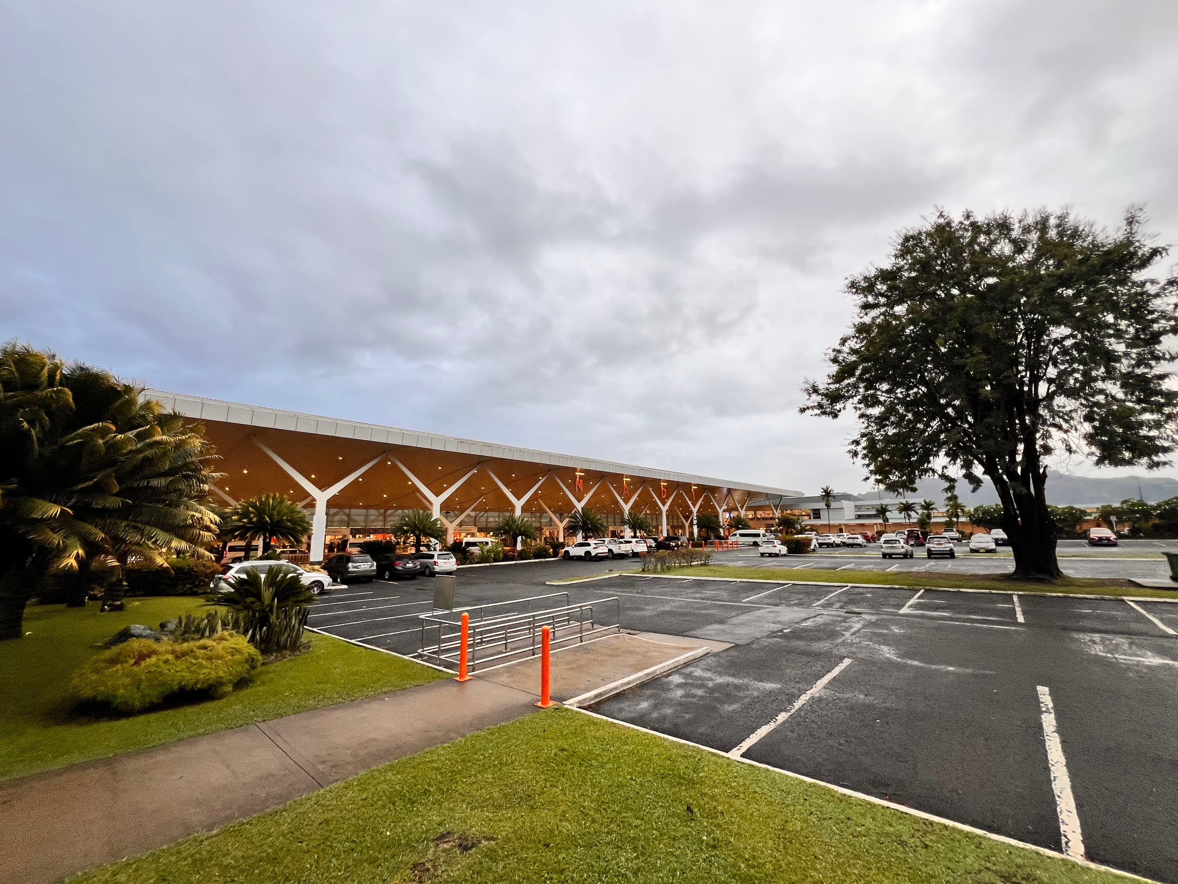 Nadi terminal facade behind landscaped grounds and a car park