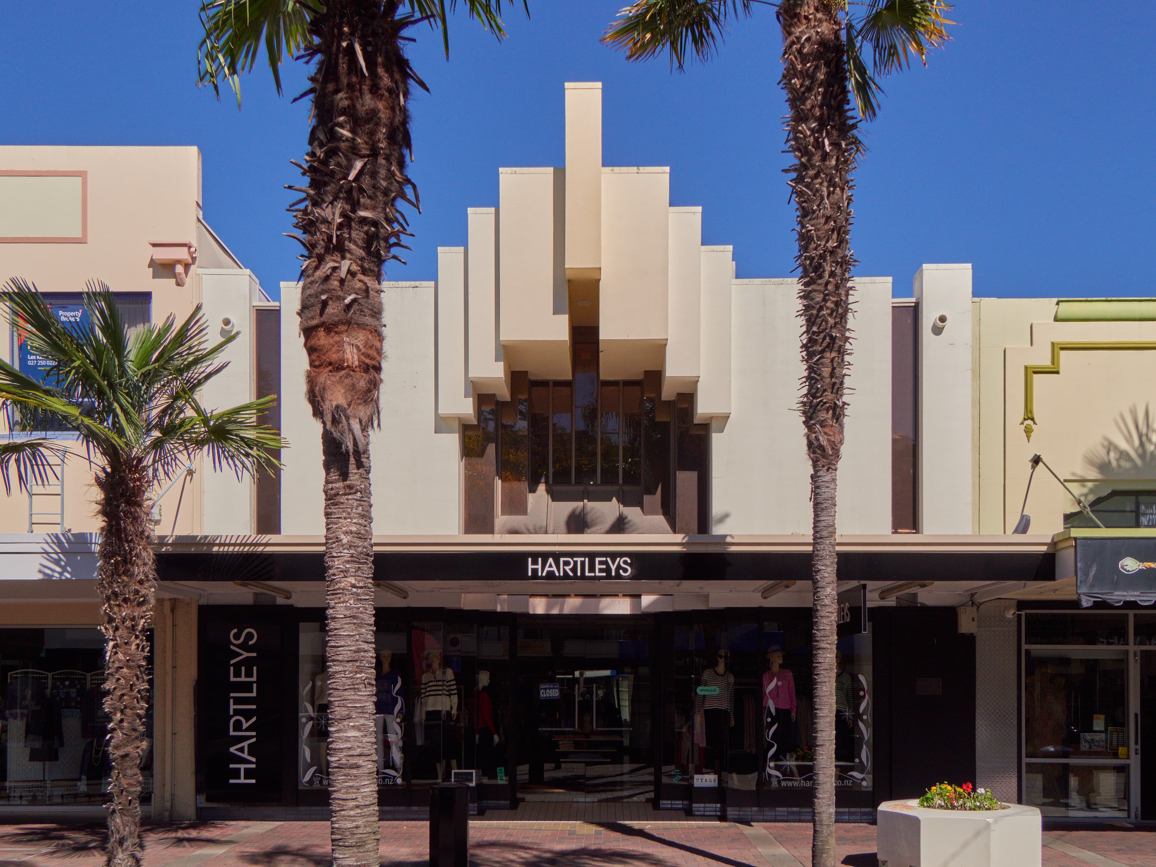 Art Deco Hartleys shopfront and palm trees on Emerson Street in Napier